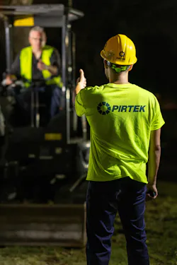 PIRTEK Technician standing in front of a machine PIRTEK Technician standing in front of a machine