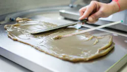 Hand Smearing Bioderived Overbased Calcium Sulphonate Grease Over a Surface Hand Smearing Bioderived Overbased Calcium Sulphonate Grease Over a Surface