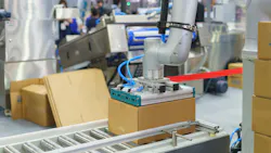 Box on Automated Conveyor System being picked up by a robot Box on Automated Conveyor System being picked up by a robot