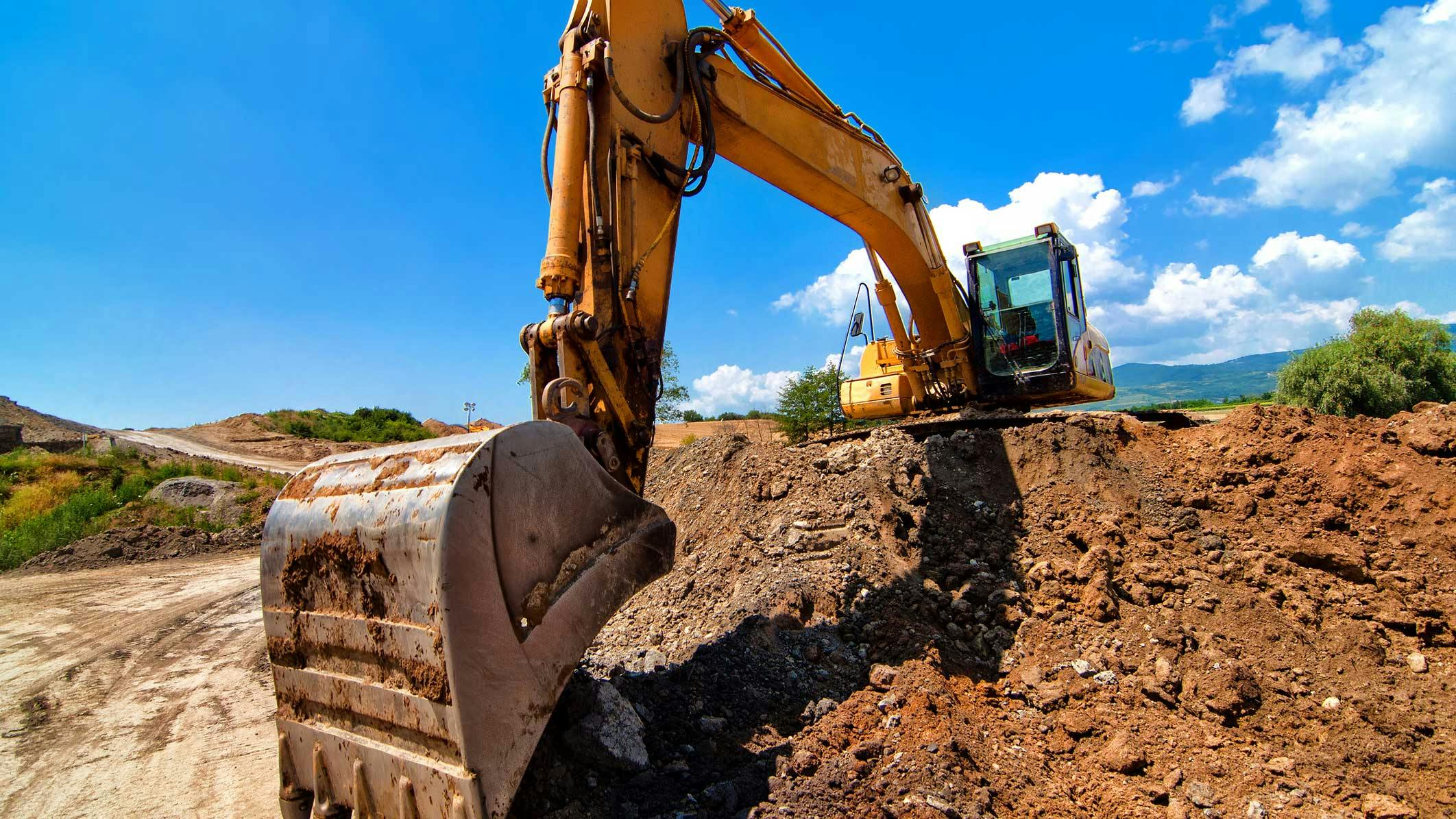 Excavator Digging into Dirt