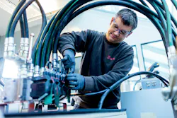 Man testing hydraulic hoses