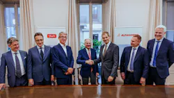 Executives from Danfoss and Alfagomma standing behind a table and shaking hands at Signing of Acquisition Agreement