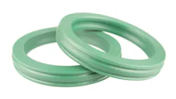 Two Green Colored Hydraulic Seals on a White Background