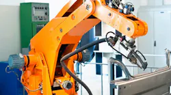 Orange robot working on a production line