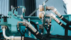 Close up on hydraulic hoses on a blue colored machine