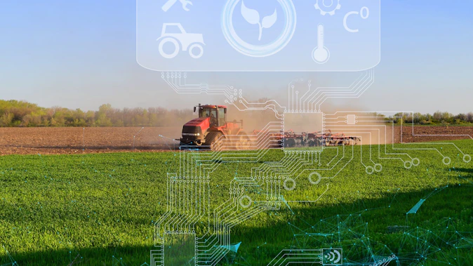 Tractor working in farm field with graphics overlaid to illustrate concept of digital technologies