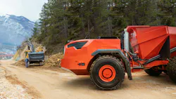 Autonomous machine concept with no operator cab working on a job site
