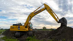 Komatsu PC365LC-11 excavator Pouring Dirt into a Dirt Pile
