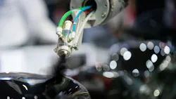 Close up of paint being sprayed by a robot