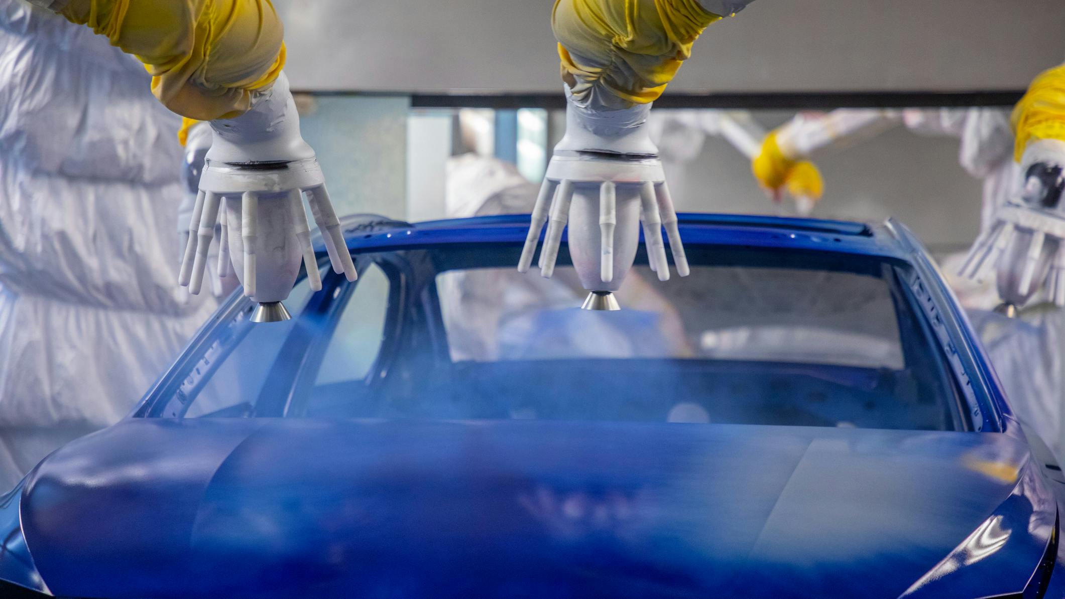 Robots painting a car blue