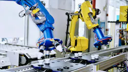Blue and yellow robots working along a production line
