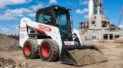 Skid steer with HYDAC logo working on a job site