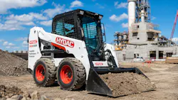 Skid steer with HYDAC logo working on a job site