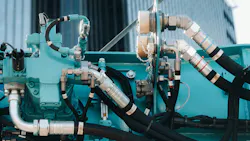 Close up on hydraulic hoses and other hydraulic components on a machine