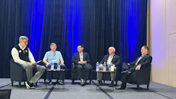 5 men sitting in chairs on a stage for panel discussion on hydraulic technology needs for automation