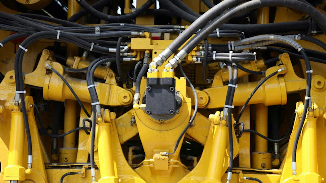 Close Up on Several Hydraulics Components on a Yellow Machine