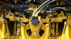 Close Up on Several Hydraulics Components on a Yellow Machine