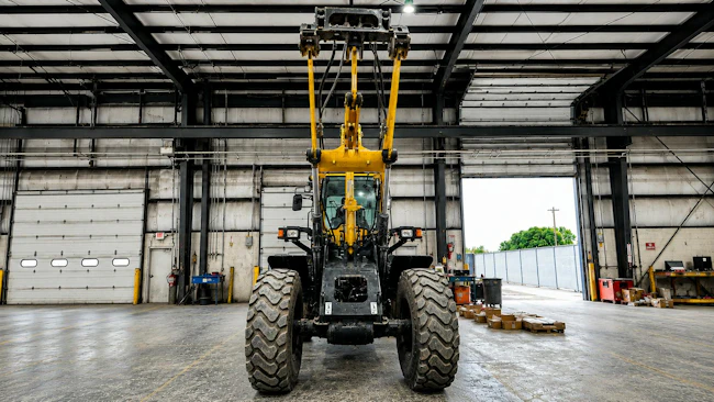 Underside view of wheel loader arm with HKX Auxiliary Hydraulics Kit installed on it