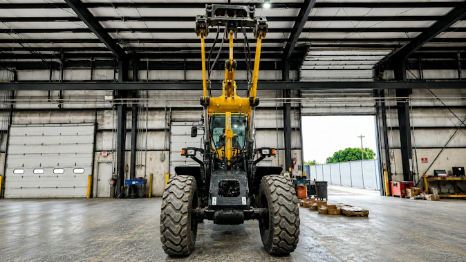 Underside view of wheel loader arm with HKX Auxiliary Hydraulics Kit installed on it
