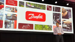 Kim Fausing, President & CEO of Danfoss, presenting in front of a screen with Danfoss imagery on it