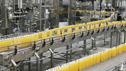 Filled bottles moving down an automated production line