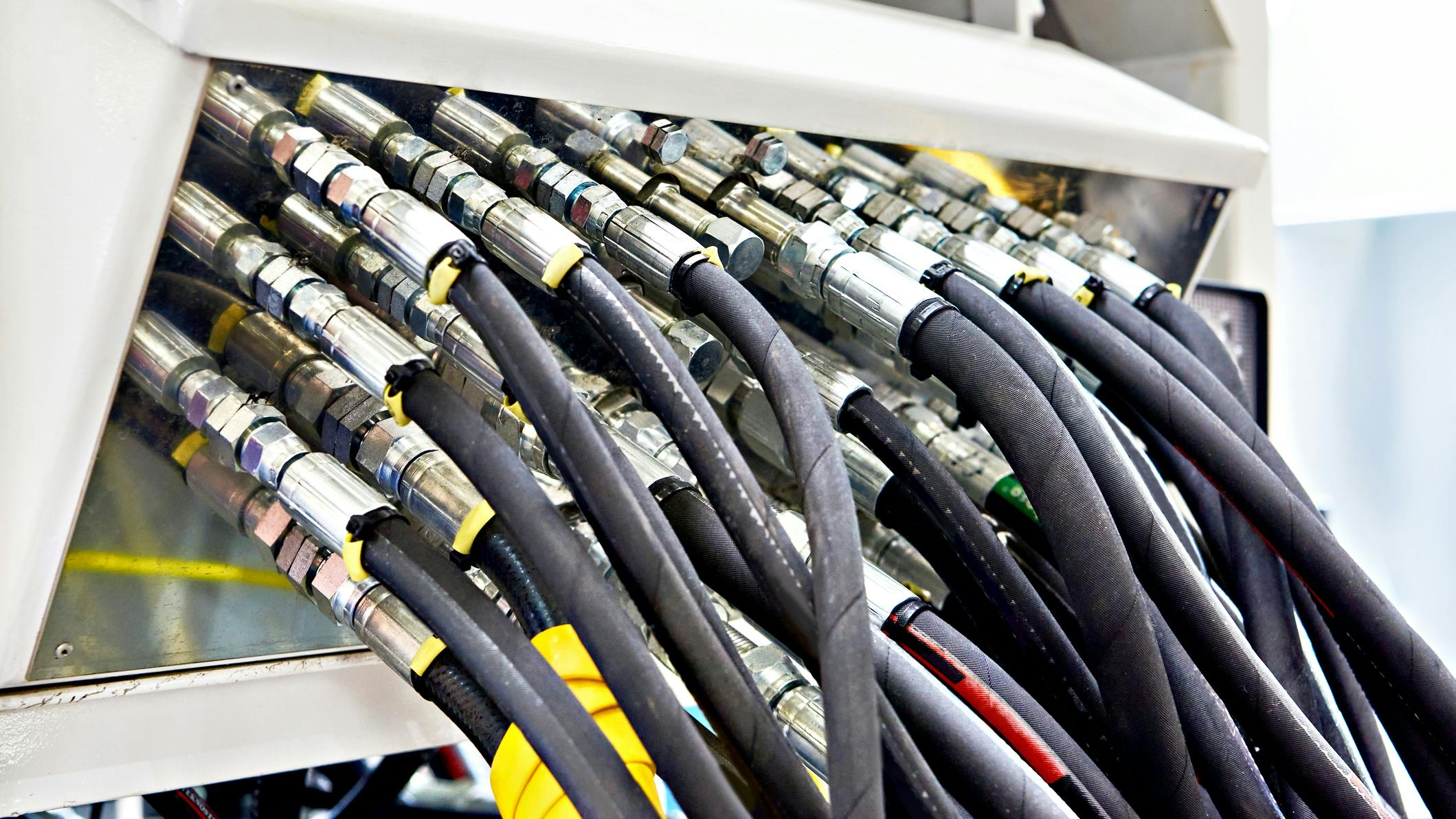 Several hydraulic hoses connected to a machine
