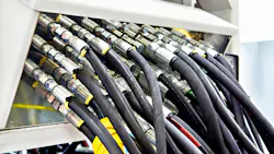 Several hydraulic hoses connected to a machine