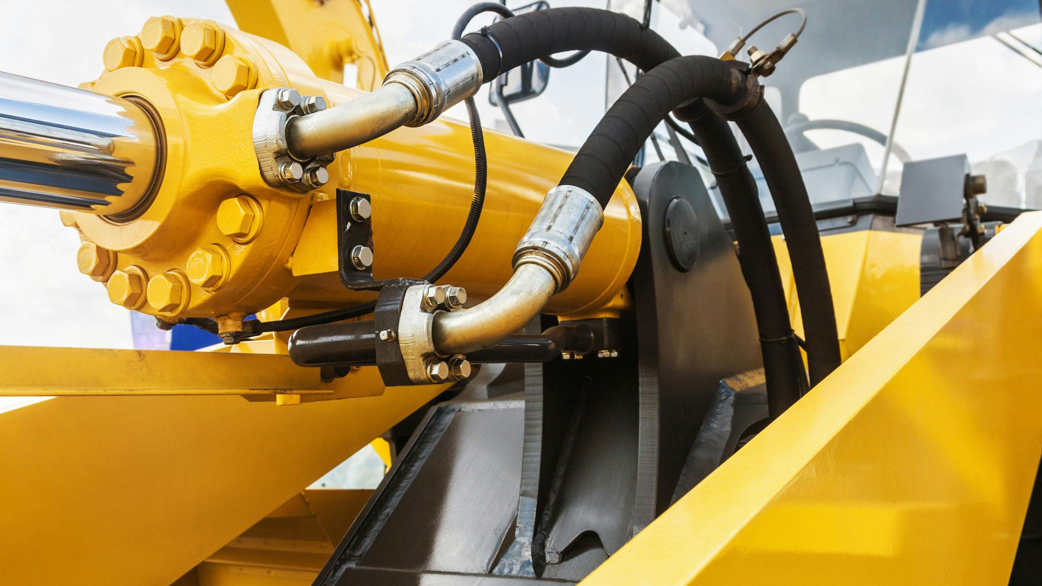 Close up on Hydraulic Hoses and Cylinder on a Machine
